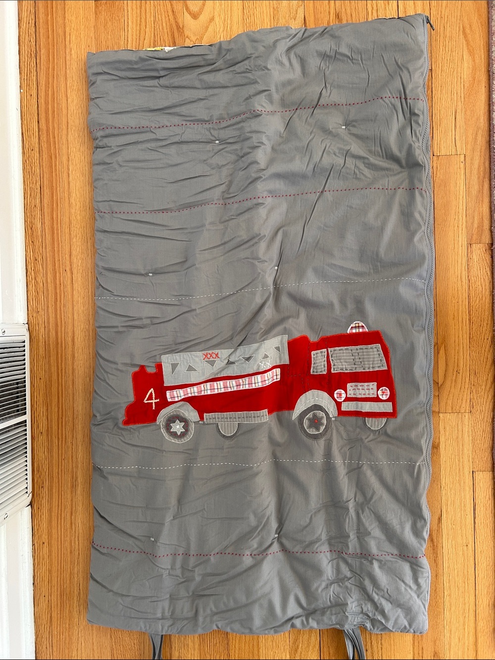 Pottery Barn Kids gray sleeping bag with fire truck for preschoolers